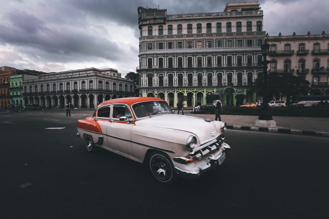 Add a vintage car in the background using Framia Pro