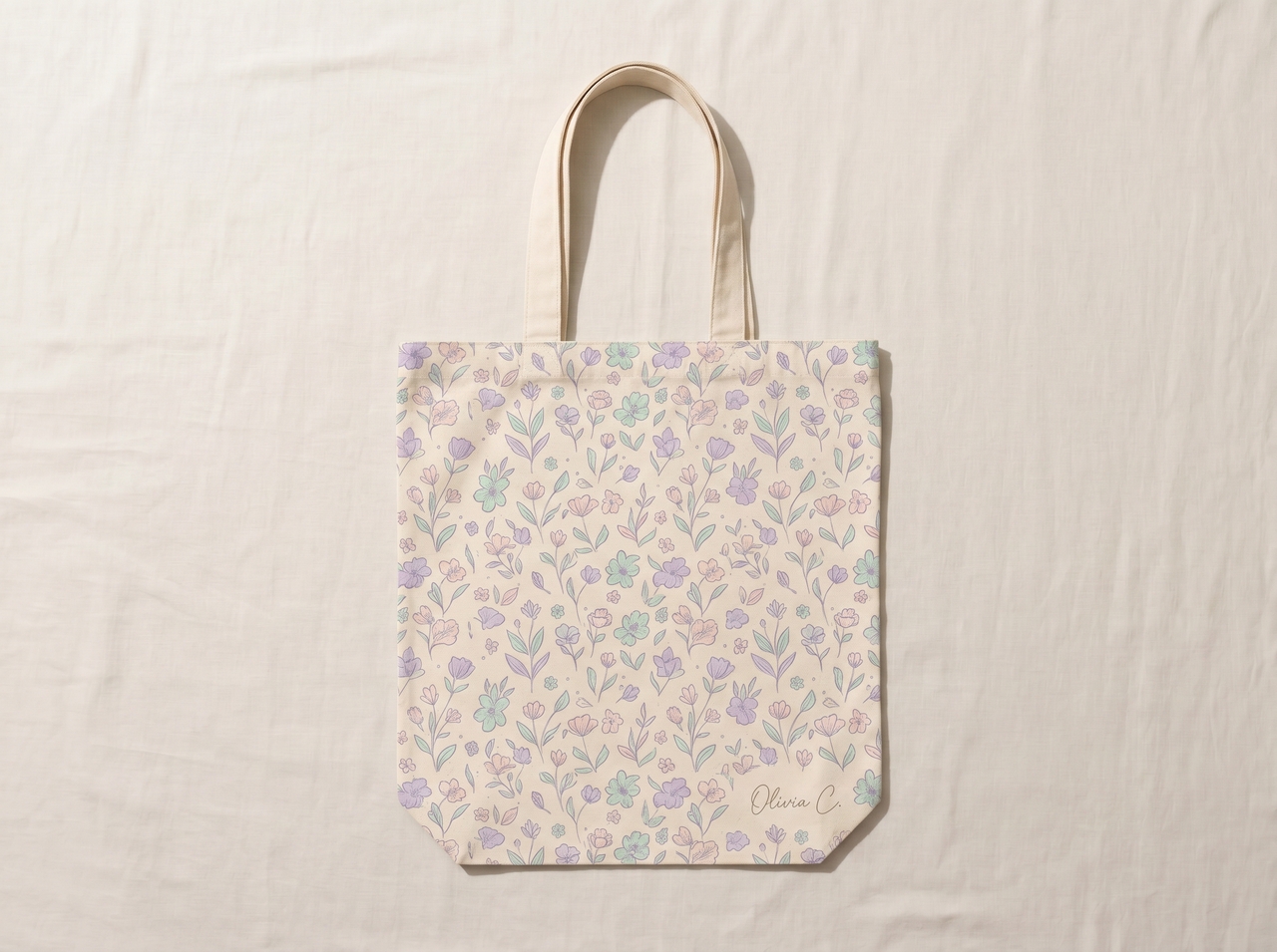 - Design a pastel tote bag with a floral pattern and a small signature logo."